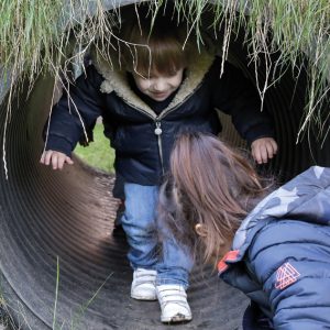 children walking through tunnel
