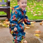 child jumping in a buddle