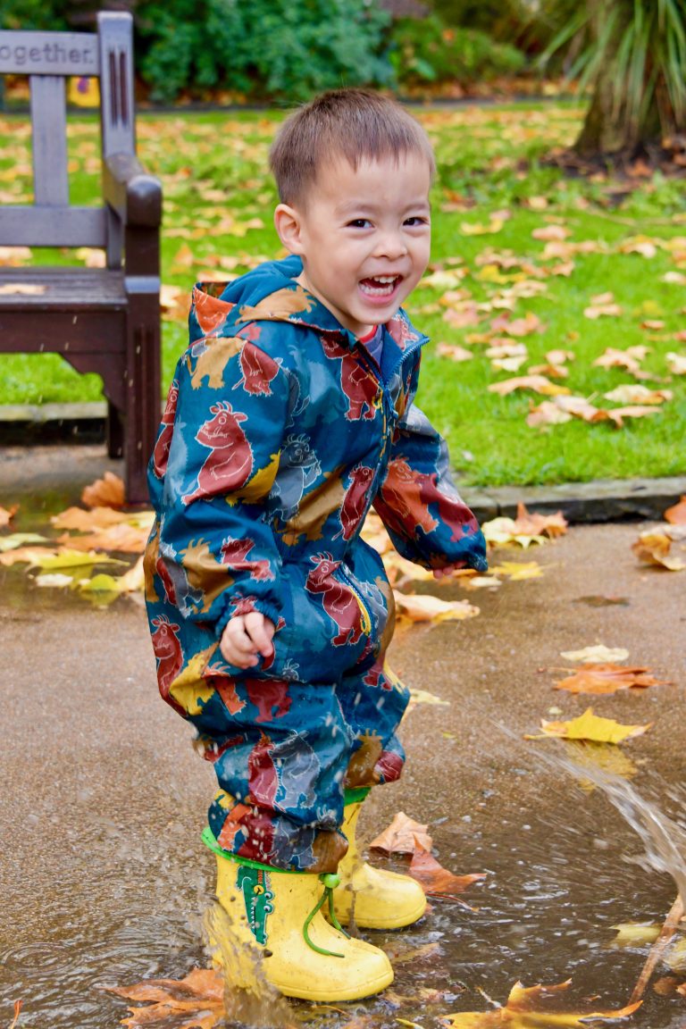 child jumping in a buddle