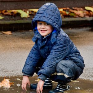 child wearing a blue coat