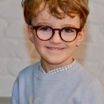 child smiling with glasses