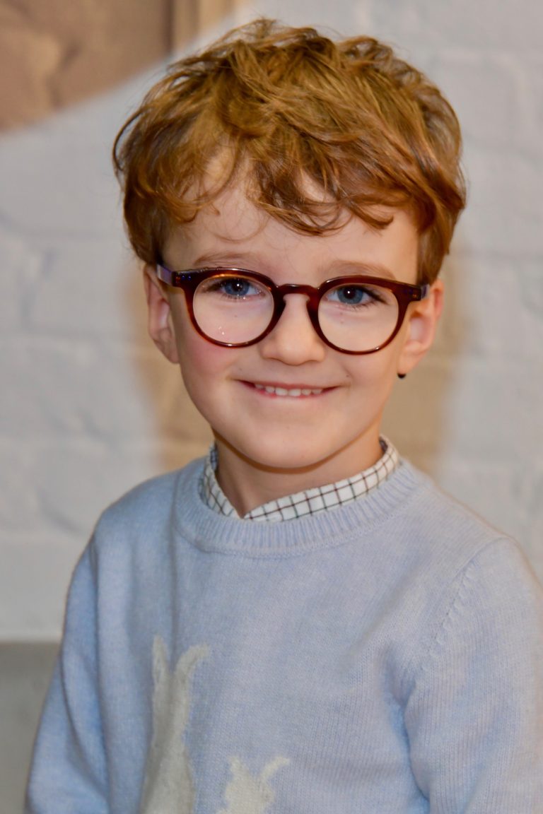 child smiling with glasses