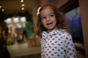 girl with a bow in her hair smiling