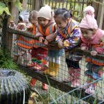 children looking at a water fountain