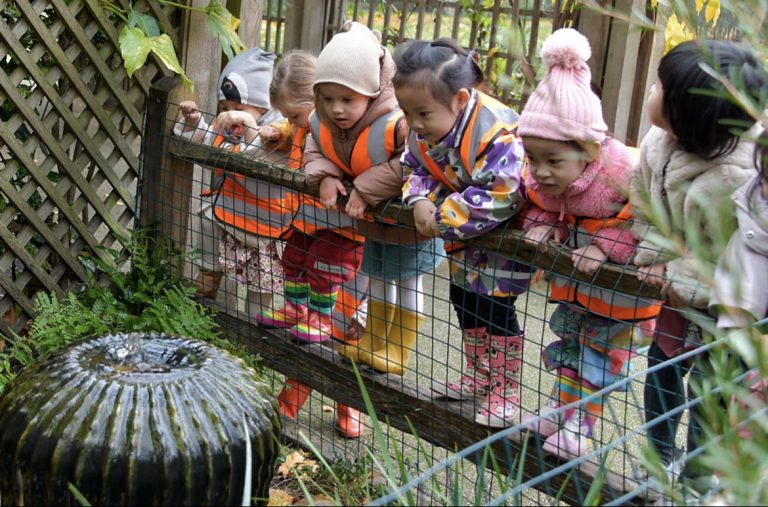 children looking at a water fountain