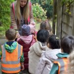 children on a walk with their teacher