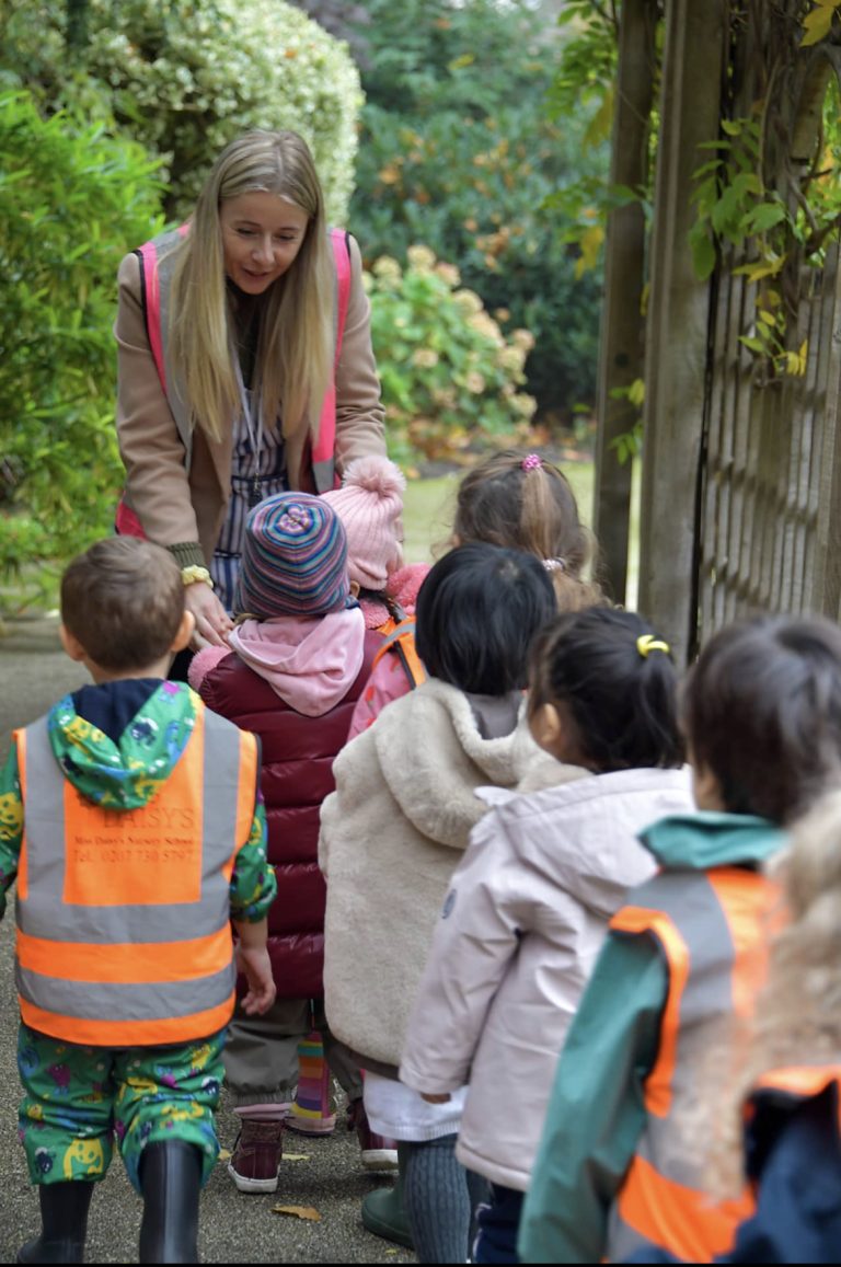 children on a walk with their teacher