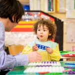 Child working on plastic toys