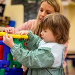 child using building blocks to connect together