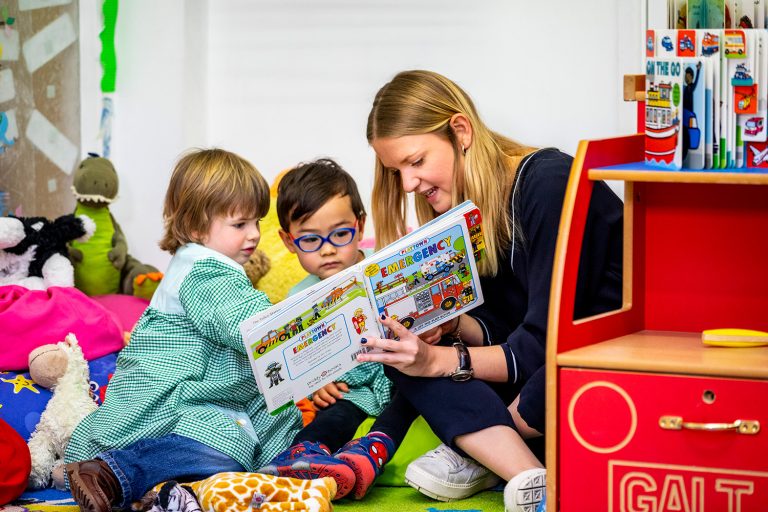 children reading a book together