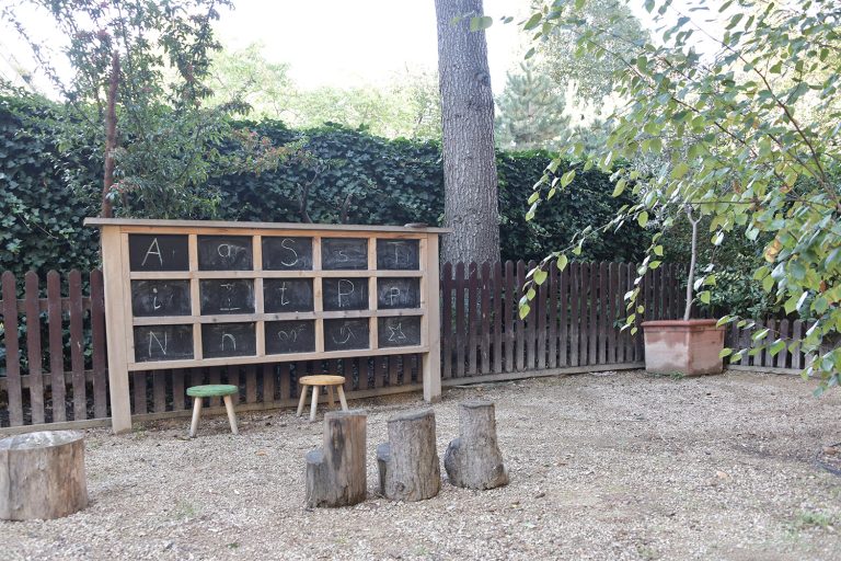 Logs and a chalkboard outside
