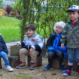 4 children sat around the garden
