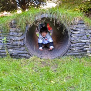 child crawling through tunnel