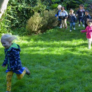 happy children running in the grass