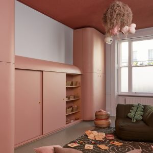 pink play area with a rug and sofa