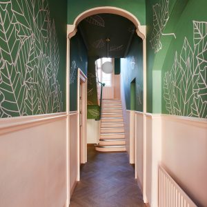 narrow school corridor with stairs in the distance