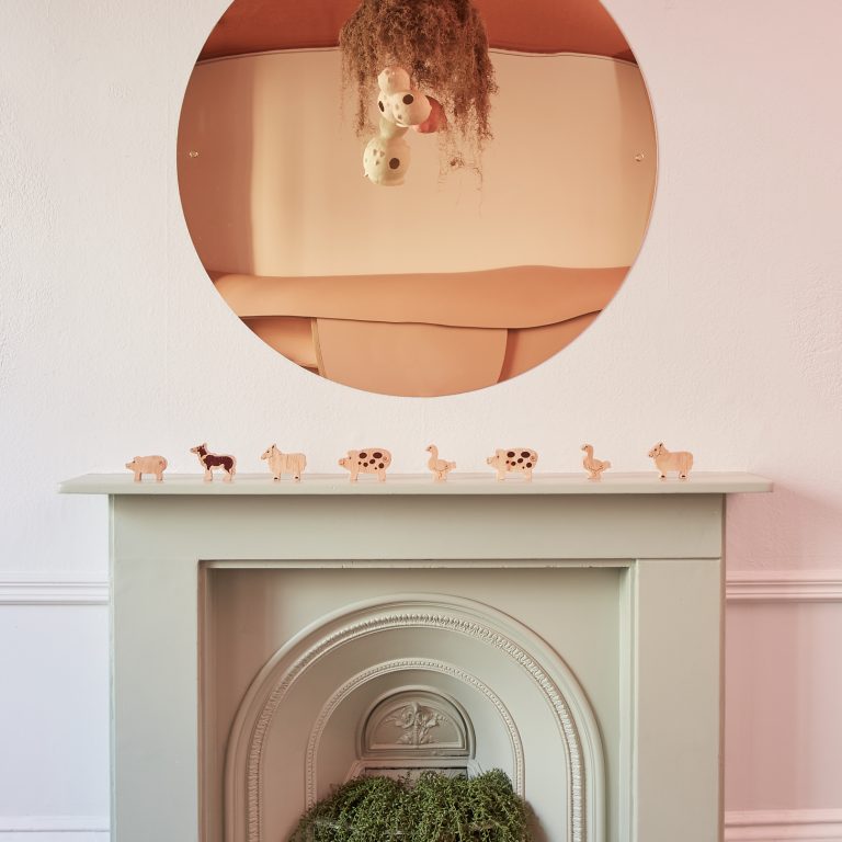 fireplace with animal cutouts on mantlepiece