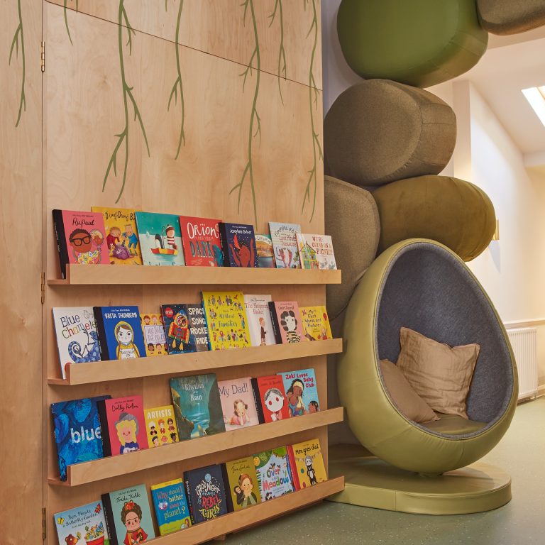 decorated bookshelf area and seat shaped like an egg